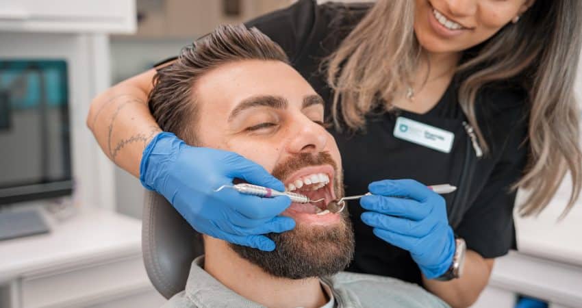 a person brushing a person's teeth